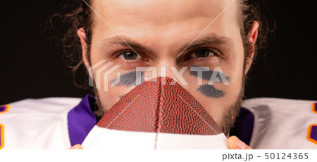 Close up portrait of American Football Player with ball Close up portrait of American Football Player with ball 50124365
