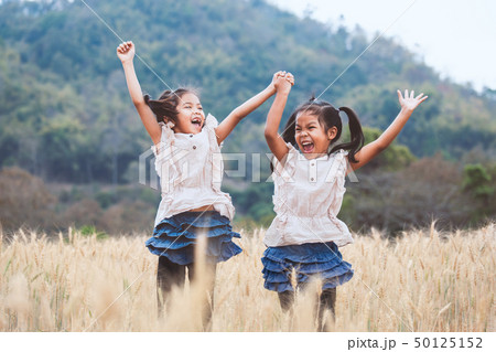 Two asian girls play and jump together 50125152