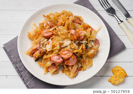 Stewed cabbage with sausages in a plate Stewed cabbage with sausages in a plate 50127959