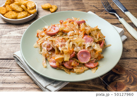 Stewed cabbage with sausages in a plate Stewed cabbage with sausages in a plate 50127960