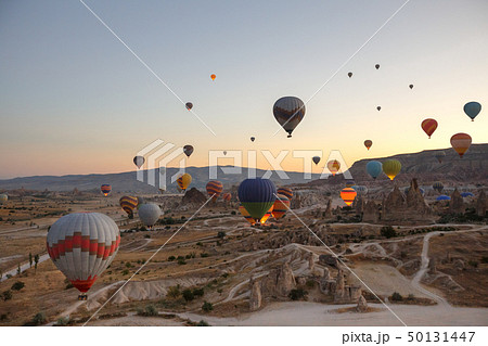 Hot air balloons flying over landscape Cappadocia 50131447