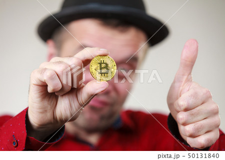 Man holding golden bitcoin Man holding golden bitcoin 50131840