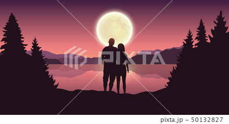 young couple looks to the full moon at beautiful lake 50132827