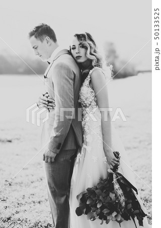 Wedding couple, groom and bride hugging, outdoor near river 50133525
