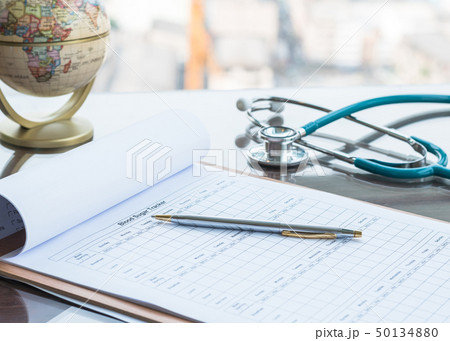 Patient blood glucose record on doctor work table 50134880