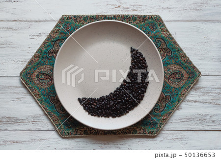 Coffee beans in moon shape on a plate. 50136653