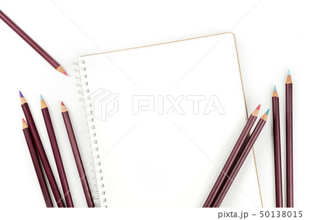 An overhead photo of a shetchbook with many different color pencils around it, shot from the top on An overhead photo of a shetchbook with many different color pencils around it, shot from the top on 50138015