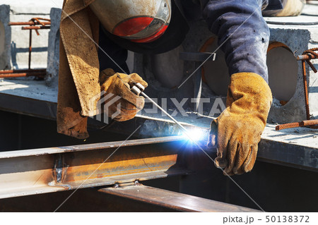 Worker welding in a factory. Welding on an industrial plant. 50138372