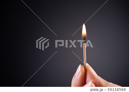 Close up woman hand holding a burning match. Close up woman hand holding a burning match. 50138569