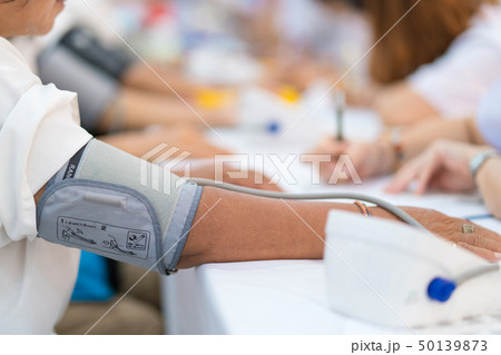 Doctor checking patient arterial blood pressure  50139873