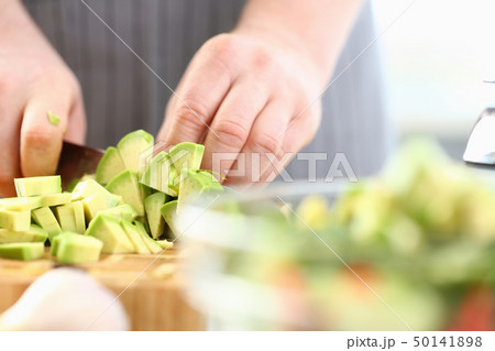 Professional Chef Hands Chopping Exotic Avocado 50141898