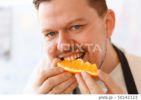 Professional Chef Bite Orange Slice Portrait Professional Chef Bite Orange Slice Portrait 50142123