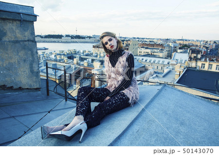 cool blond real fashion style girl posing sensual on roof top, lifestyle people concept cool blond real fashion style girl posing sensual on roof top, lifestyle people concept 50143070