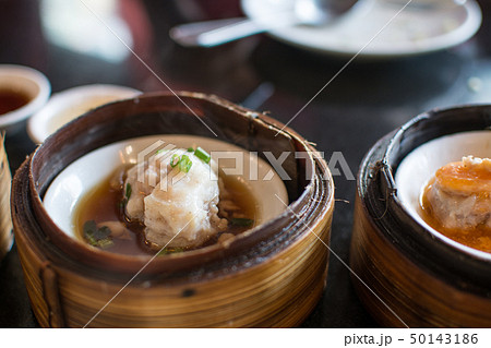 Chinese dim sum in a bamboo steamer box Chinese dim sum in a bamboo steamer box 50143186