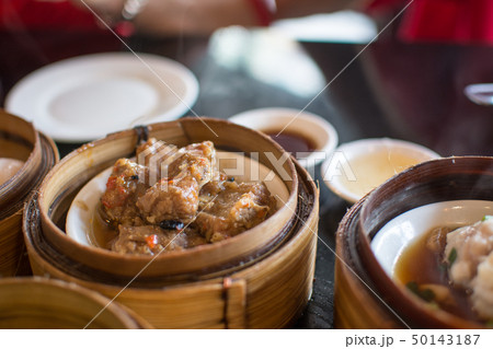 Chinese dim sum in a bamboo steamer box Chinese dim sum in a bamboo steamer box 50143187
