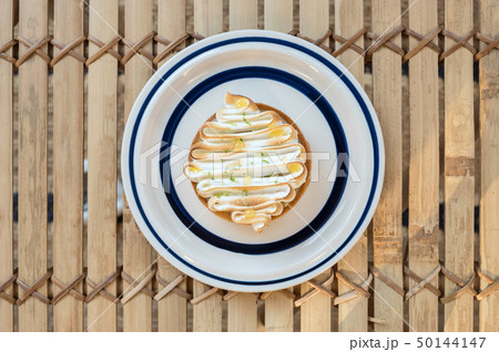 Homemade lemon tart decorated with meringue swirls 50144147