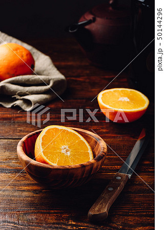 Half of orange in a wooden bowl Half of orange in a wooden bowl 50144296