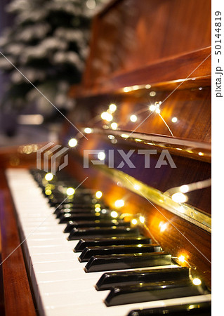 Piano keyboard with christmas light in the evening Piano keyboard with christmas light in the evening 50144819