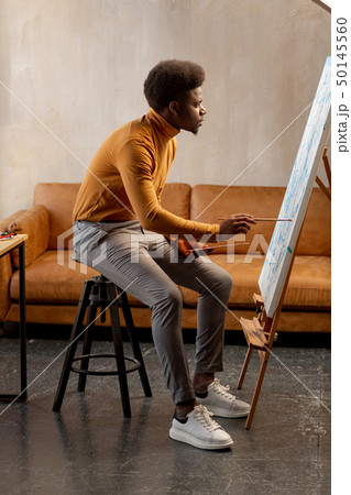 Talented young man looking at the canvas Talented young man looking at the canvas 50145560