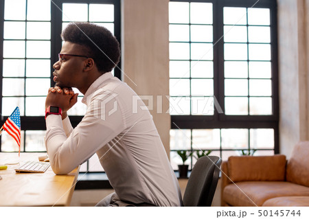Thoughtful African American man thinking about his work 50145744