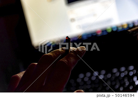 male hand holding a cigarette 50146594