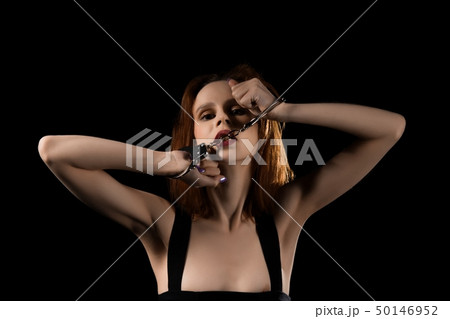 Sexy woman in handcuffs and dress portrait Sexy woman in handcuffs and dress portrait 50146952