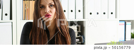 Beautiful smiling clerk girl at workplace talk to visitor 50156779