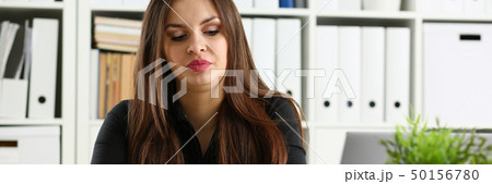 Beautiful smiling clerk girl at workplace talk to visitor Beautiful smiling clerk girl at workplace talk to visitor 50156780