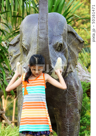 Asian girl enjoying with elephant statue in the 50161471