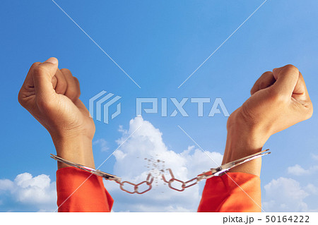 two hands of prisoner with broken handcuff  50164222