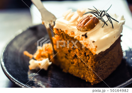 carrot cake with walnuts on dark background 50164982