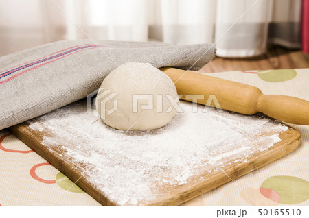 fresh raw dough and rolling pin 50165510