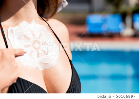 Beautiful woman has a sunscreen in sun shape on Beautiful woman has a sunscreen in sun shape on 50166997