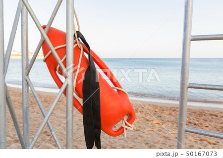 lifeguard tower with orange buoy on the beach. lifeguard tower with orange buoy on the beach. 50167073