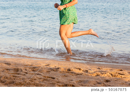 Beautiful girl legs running on the beach. pretty Beautiful girl legs running on the beach. pretty 50167075