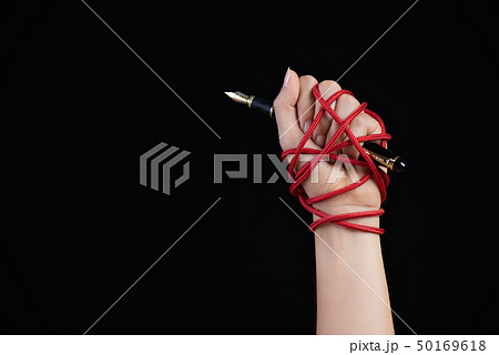 Woman hand with black pen tied with red rope, Woman hand with black pen tied with red rope, 50169618