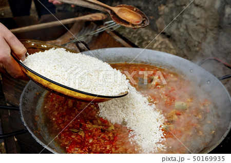 man preparing a typical spanish paella man preparing a typical spanish paella 50169935