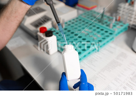 laboratory assistant analyzing a blood sample 50171983