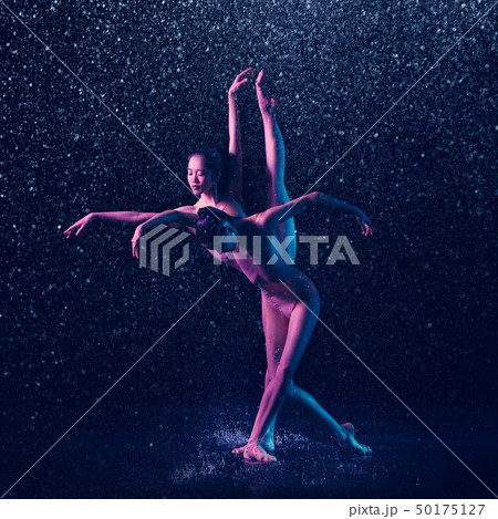 Two young female ballet dancers under water drops Two young female ballet dancers under water drops 50175127