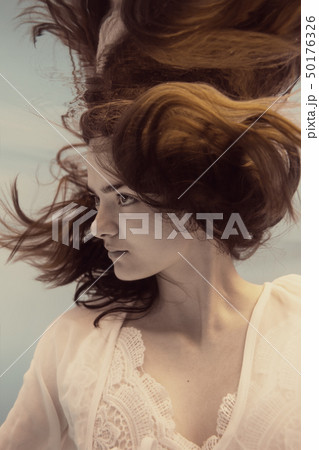 Portrait of a girl in a white dress under water 50176326