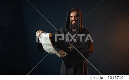 Medieval monk with an evil face reads a prayer Medieval monk with an evil face reads a prayer 50177104