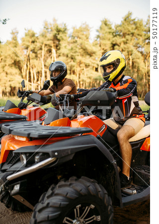 Two atv riders before the trip in summer forest 50177119