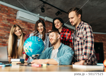Group of highschool students looking at the globe 50177525