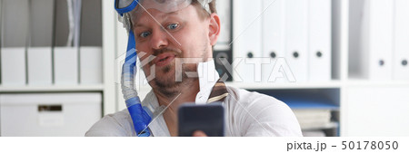 Man wearing suit and tie in goggles and snorkel Man wearing suit and tie in goggles and snorkel 50178050
