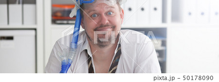 Man wearing suit and tie in goggles with snorkel Man wearing suit and tie in goggles with snorkel 50178090