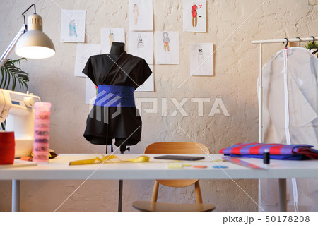 Photo of seamstress room with mannequin, table, sewing machine 50178208