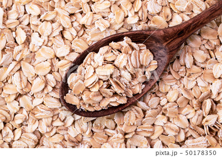 Oat flakes with wooden spoon . The form of the top Oat flakes with wooden spoon . The form of the top 50178350
