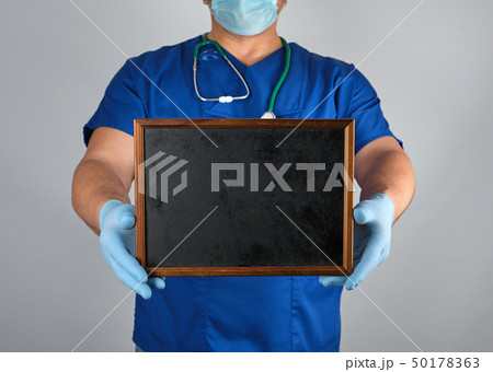 doctor in blue uniform and sterile latex gloves doctor in blue uniform and sterile latex gloves 50178363