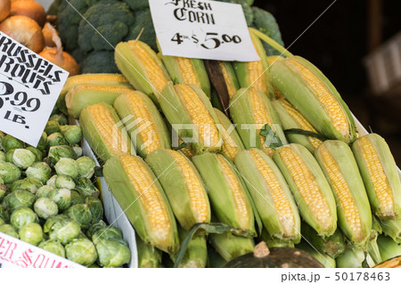 Corn cobs and brussels sprouts at a stall at Seattle's Pike Place Market. Corn cobs and brussels sprouts at a stall at Seattle's Pike Place Market. 50178463