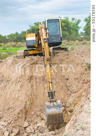 Yellow excavator machine working earth moving Yellow excavator machine working earth moving 50178595